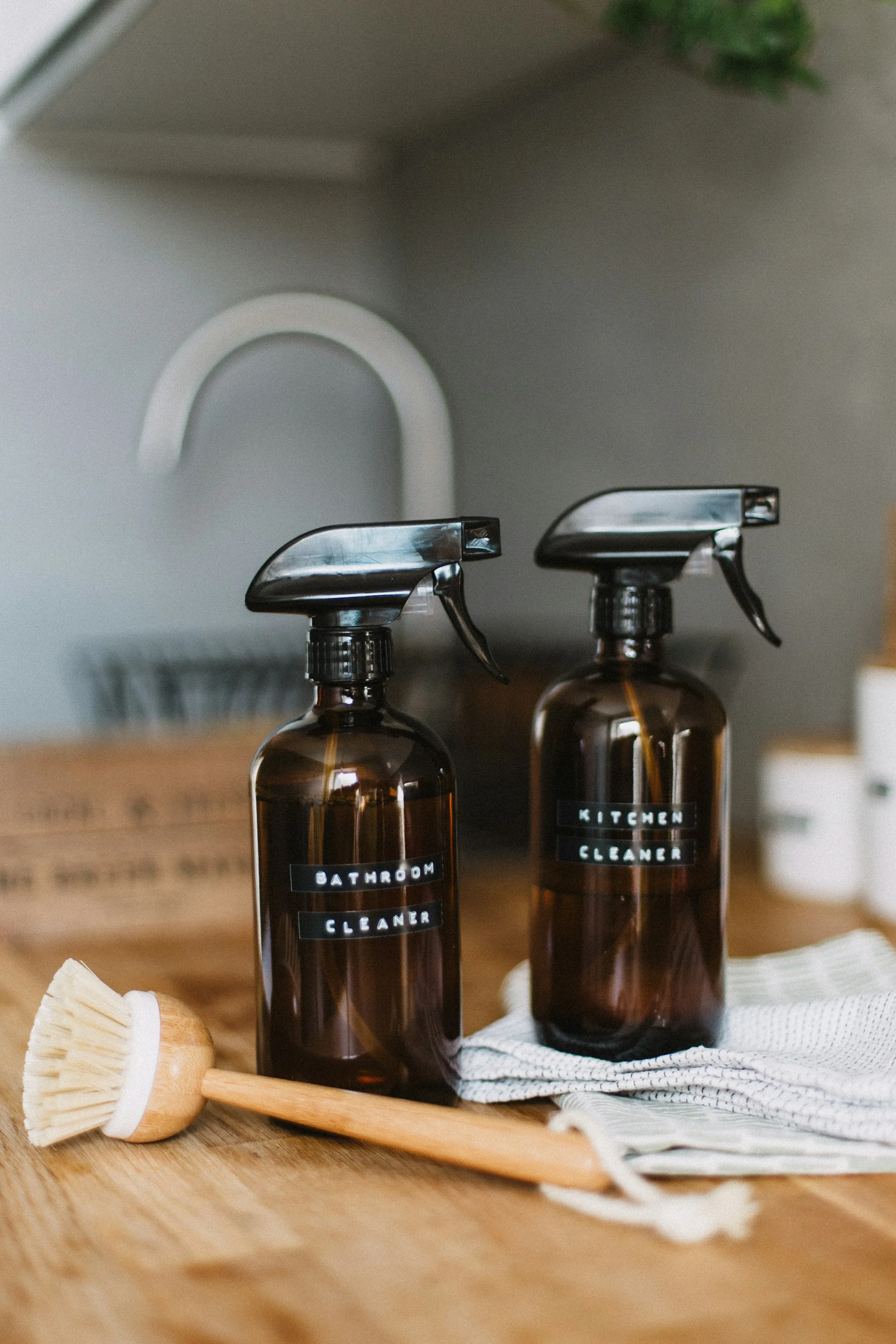 Refillable amber glass spray bottles and a natural bristle brush